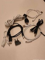 Group shot of all six USB cables, 3.5 mm audio cable and airline adapter