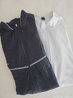 Folded black and white Vaude jerseys side by side