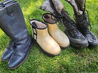 Group shot of all three boot pairs on grass
