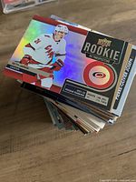 Stack of hockey trading cards; top card Upper Deck Rookie Retrospective Seth Jarvis