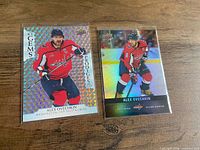 Front view of two Alex Ovechkin Upper Deck hockey cards in sleeves on tabletop