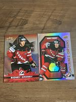Front view of two Sidney Crosby Tim Hortons Team Canada cards, red variant and holographic Captains subset