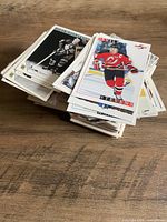 Stack of approximately 350 mixed hockey trading cards on tabletop