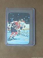 Front view of signed Bobby Clarke hockey card in protective sleeve