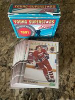 Box labeled “Young Superstars 1991 Score” with stack of hockey rookie cards, Eric Lindros card visible on top