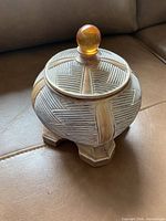 Full view of ceramic pot with lid and finial