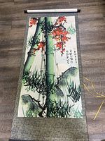 Full view of hanging scroll showing artwork, borders and rods