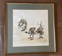 framed print showing three fairies with shovels within wood frame and mat