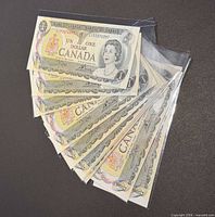 Stack of ten Canadian $1 notes in plastic sleeves