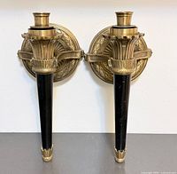 Front view of both brass sconces mounted upright