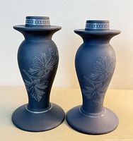 Front view of both Wedgwood blue jasperware candlestick holders