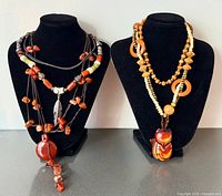 All three necklaces displayed on two bust stands