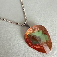 Necklace laid out showing crystal pendant and chain