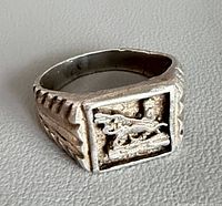 Front angled view of ring showing Lion of Judah relief and bezel
