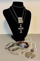 Overall lot on display bust and tabletop showing necklaces, bracelets, pendant, collar