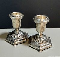 Pair of sterling silver candleholders front view