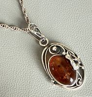 Front view of sterling amber pendant on chain