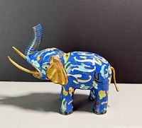 Left side view showing full cloisonné pattern and brass tusks