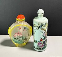 Front view of both bottles showing designs and size contrast