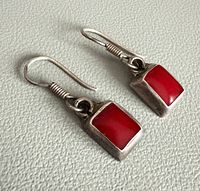 Front view of both earrings showing coral stones and silver setting