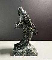 Front left view of stone killer whale sculpture