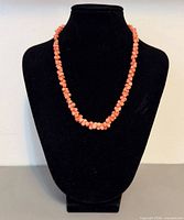 Necklace displayed on black bust showing overall appearance and color