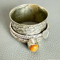 Ring angled showing tiger eye stone and heart accent