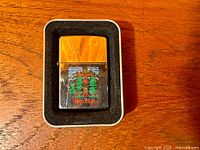 Lighter in tin case showing overall appearance