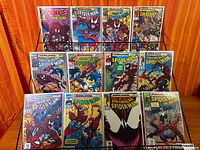 Front view of 13 bagged comics on rack