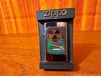 Front view of chrome Slimline Zippo lighter on black display stand