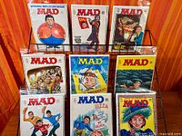 Front view showing all nine MAD magazines on rack