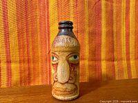 Front view of painted Certo bottle showing face detail