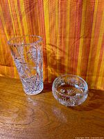 Tall cylindrical vase and round bowl vase side by side displaying overall forms and cut pattern