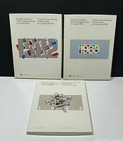 Front covers of the three Canada Post souvenir stamp albums for 1982, 1983, 1984