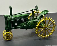 Left side view of die-cast John Deere tractor showing overall form and colours