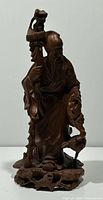 full view of carved Shou Lao figure showing staff, crane, base and signature area