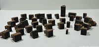 Group view of 40 wooden letterpress blocks arranged on surface