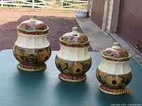 Three ceramic canisters with lids, full view
