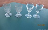 Four cordial glasses aligned to show overall styles