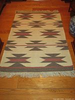 Full view of rectangular dhurrie rug showing entire pattern and fringe