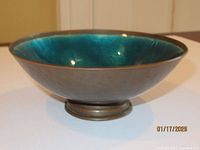 Side view showing blue enamel interior and copper exterior