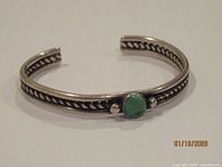 Full view of sterling cuff bracelet showing turquoise stone and decorative band