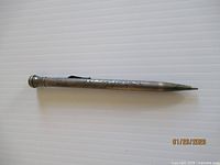 Full view of Wahl Eversharp sterling silver mechanical pencil, showing engraved body and clip