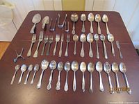 Entire group of flatware laid out on table