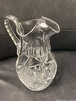 Full view of cut glass pitcher showing handle and spout