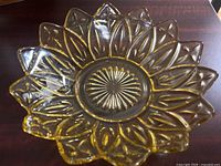 Top view showing sunflower petal design and amber color