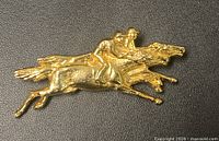 Full view of gold-tone brooch showing entire horse and jockey design