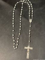 Full view of rosary showing beads, center medal and crucifix