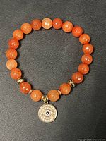 Full view of entire bracelet showing bead arrangement and charm