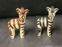 Both zebra figurines front view